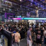A bustling crowd at a technology convention, showcasing vibrant energy and diverse attendees.