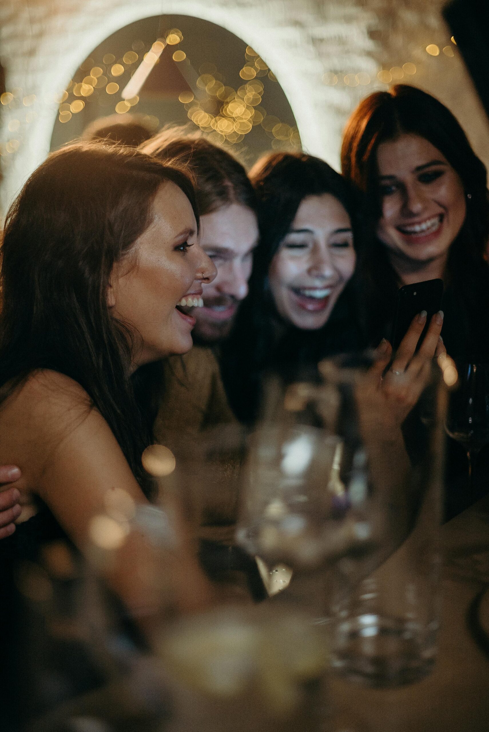 A joyful group of friends enjoying a celebration indoors, sharing laughter and happiness.