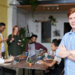 Young professional leading a diverse team in a contemporary office setting.